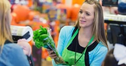 grocery store employee helping customer