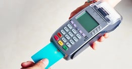 hand inserting card into pos system card reader