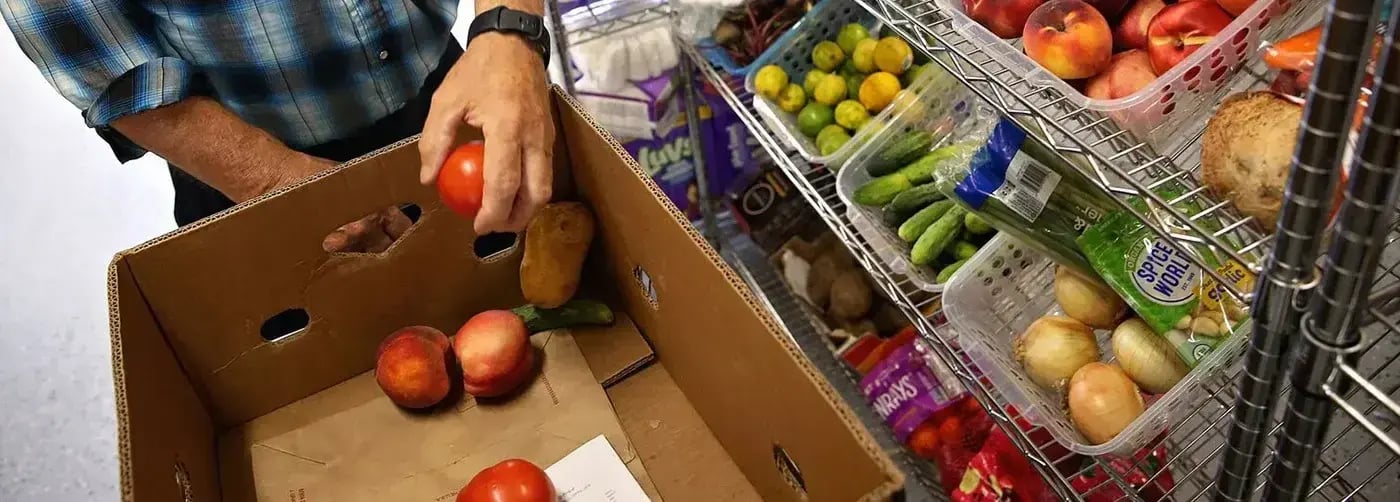 employee donating perishable groceries